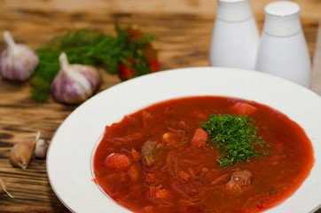 Russian borsch with meat and sour cream on the table
