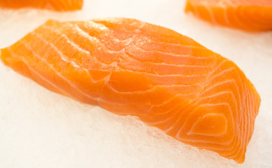 Red fish with ice slices on a ice  background