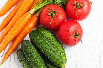 Ripe carrots, tomatoes, cucumbers in the fruit and vegetable market
