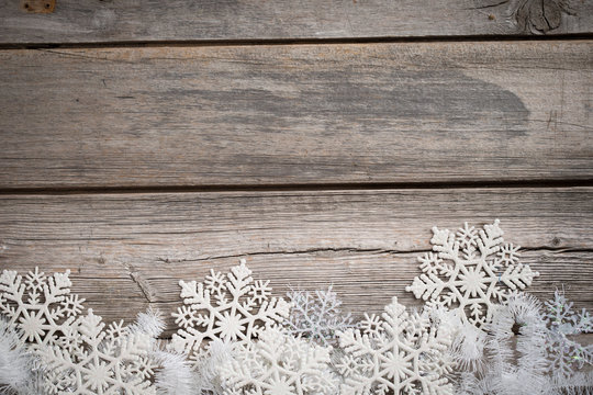 white tinsel and snowflakes on wooden board