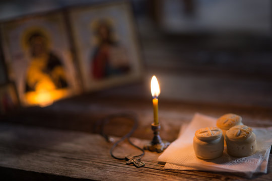 andle against the background of orthodox icons