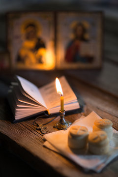 andle against the background of orthodox icons