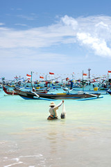 Travel destinations, island culture. Fisherman in the ocean, Bali, Indonesia.