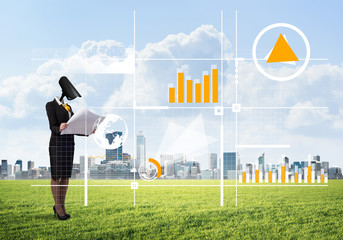 Camera headed woman standing on green grass against modern cityscape