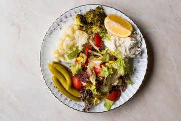 Vegetable Plate with Cauliflower, Celery, Broccoli, Pickle, Tomatoes and lemon.