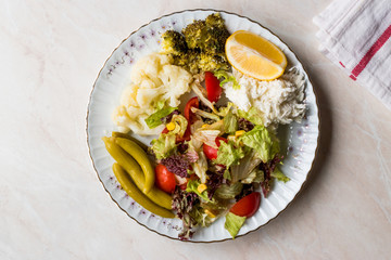 Vegetable Plate with Cauliflower, Celery, Broccoli, Pickle, Tomatoes and lemon.