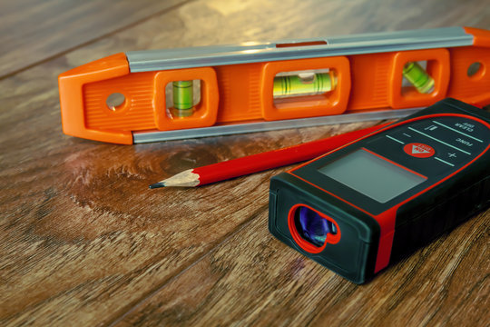 Optical level, laser range finder and a pencil lying on the floor