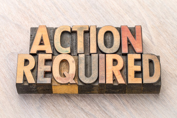 Action required - banner in wood type