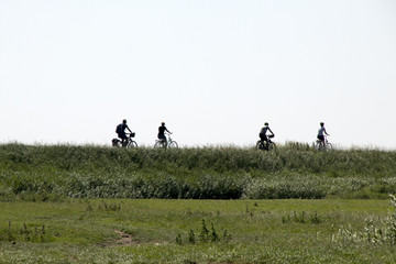Naklejka na ściany i meble bikers over the small dike of Marken