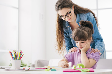 Obraz na płótnie Canvas Mother and child doing homework together