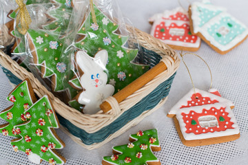 New Year's gingerbread decorated with icing in a basket. Christmas homemade gingerbread cookie in a wicker basket. Christmas and new year card with free text space.