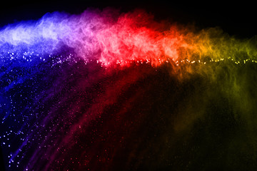 abstract powder splatted background. Colorful powder explosion on black background. Colored cloud. Colorful dust explode. Paint Holi.
