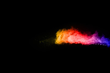 abstract powder splatted background. Colorful powder explosion on black background. Colored cloud. Colorful dust explode. Paint Holi.
