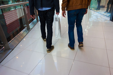 Fototapeta premium low section view of two men shopping