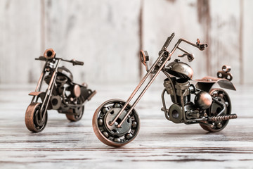 Fototapeta na wymiar Mini Metal Model Motorcycle on White Wooden Background