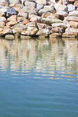 Dam with stone blocks for protection from sea storms - image with copy space