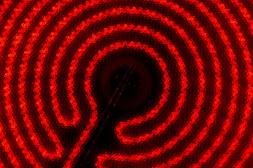 The hob of cooktop. Glowing spiral on the black background
