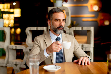 Handsome man drinking red wine during lunch