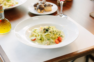 Italian food - fettuccine pasta with pesto sauce.