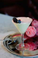 Sweet mousse dessert with berries in a glass