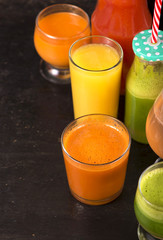 fruit and vegetable juices on a dark background