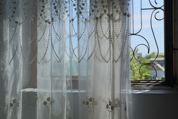 Open window with curtains and lattice