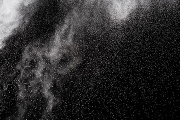 Fototapeta na wymiar White powder. Grainy abstract texture on black background.