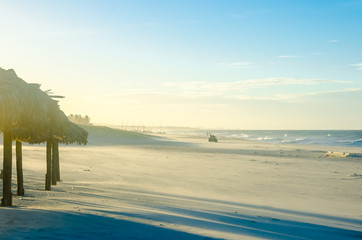 Buggy on the beach at the sunset