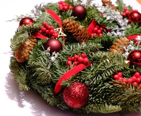 Christmas coronal of pine tree with red balls, cones and decorations, isolated