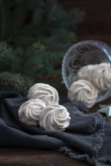 Homemade marshmallows or zephyr on the wooden background