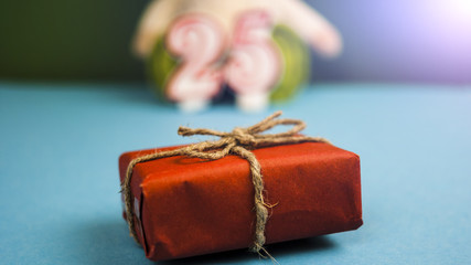 Gifts on the background of toys and figures "2" and "5" concept of a birthday, anniversary