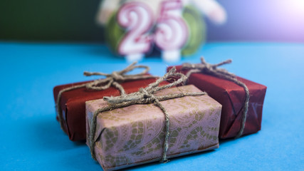 Gifts on the background of toys and figures "2" and "5" concept of a birthday, anniversary