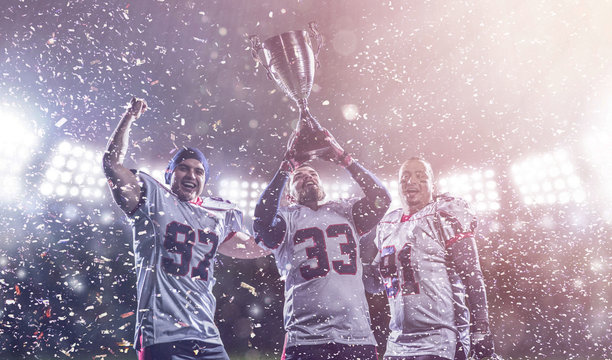 American Football Team With Trophy Celebrating Victory In The Cup Final