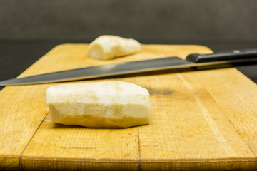 Peeled parsley root prepared for cutting.
