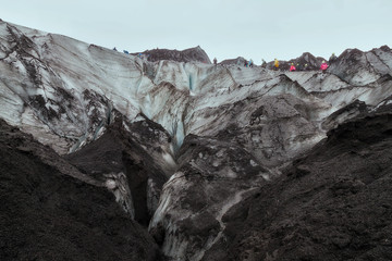 People hiking in a glacier