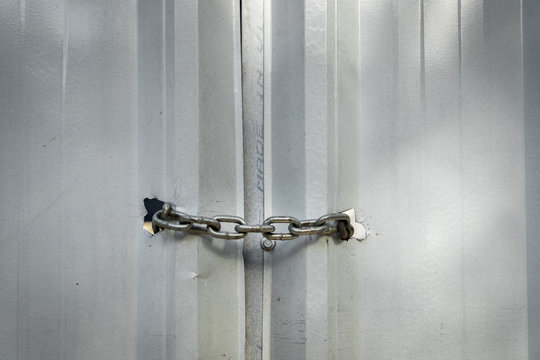 Metal chain securely locking door in an industrial setting