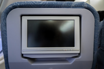 in-flight entertainment system screen of economy class seat on airplane
