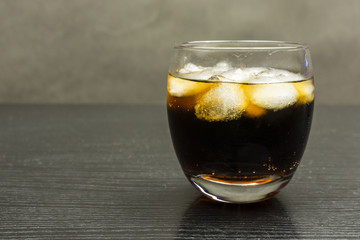 Condensed drops on a glass with cola.