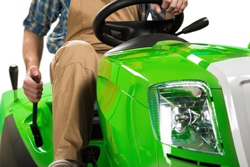 Closeup of a Gardener Riding Tractor