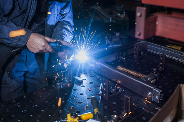 Sparks of metal from the welding machine in the shop