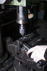 Fototapeta na wymiar worker drills metal