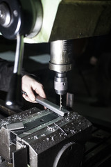 hand worker drilling metal