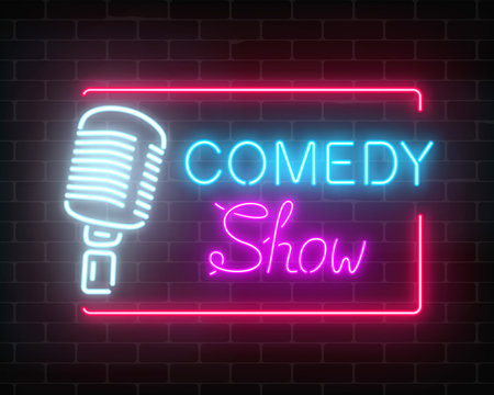 Neon comedy show sign with retro microphone on a brick wall background. Humor monolog glowing signboard.