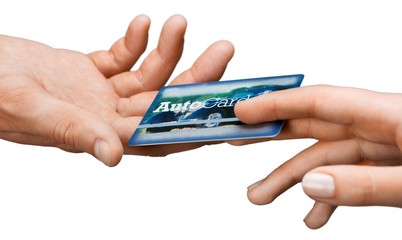 Hands Passing Credit Card