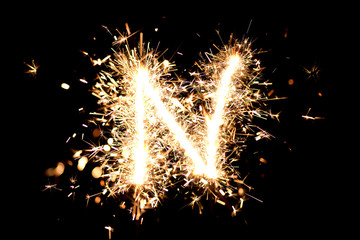 Letter "N" made of sparklers isolated background.