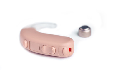 Fototapeta premium Hearing aid close up on white background with batteries