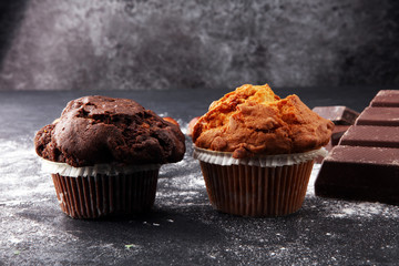 Chocolate muffin and nut muffin, homemade bakery on dark background