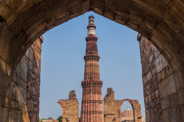 View of Qutub Minar minaret through a gate. Delhi, India.