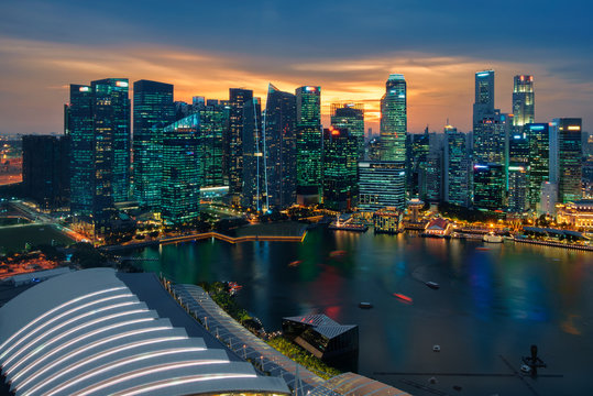Singapore city skyline. Business district aerial view. Downtown landscape reflected in water at sunset in Marina Bay. Travel cityscape
