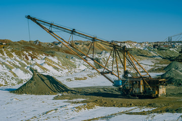 Excavators loaded manganese ore. Open development. Huge machines manganese ore is mined in open pits. Metallurgical industry in Ukraine.